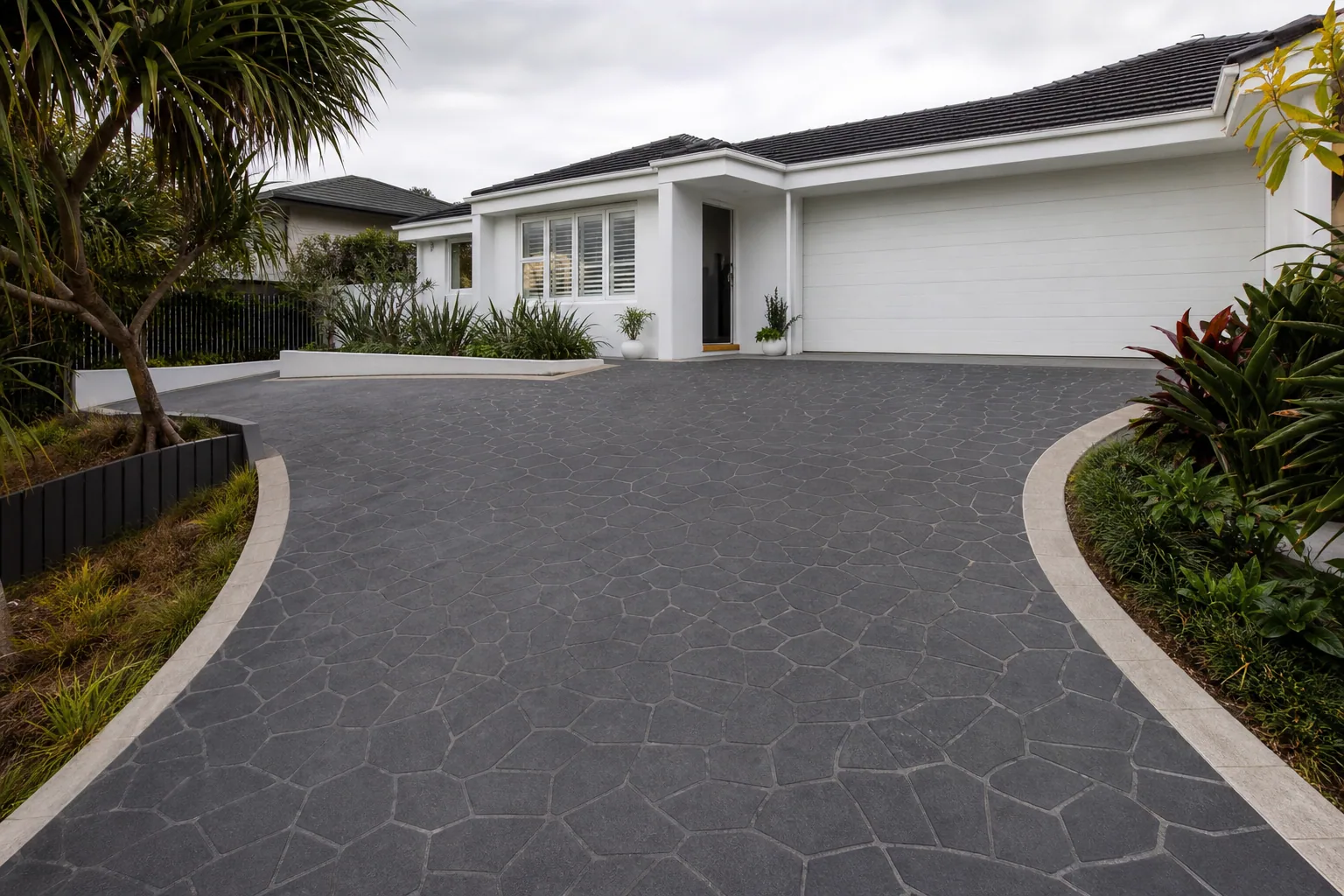 Charcoal stencil concrete driveway with a contrasting border on the Gold Coast